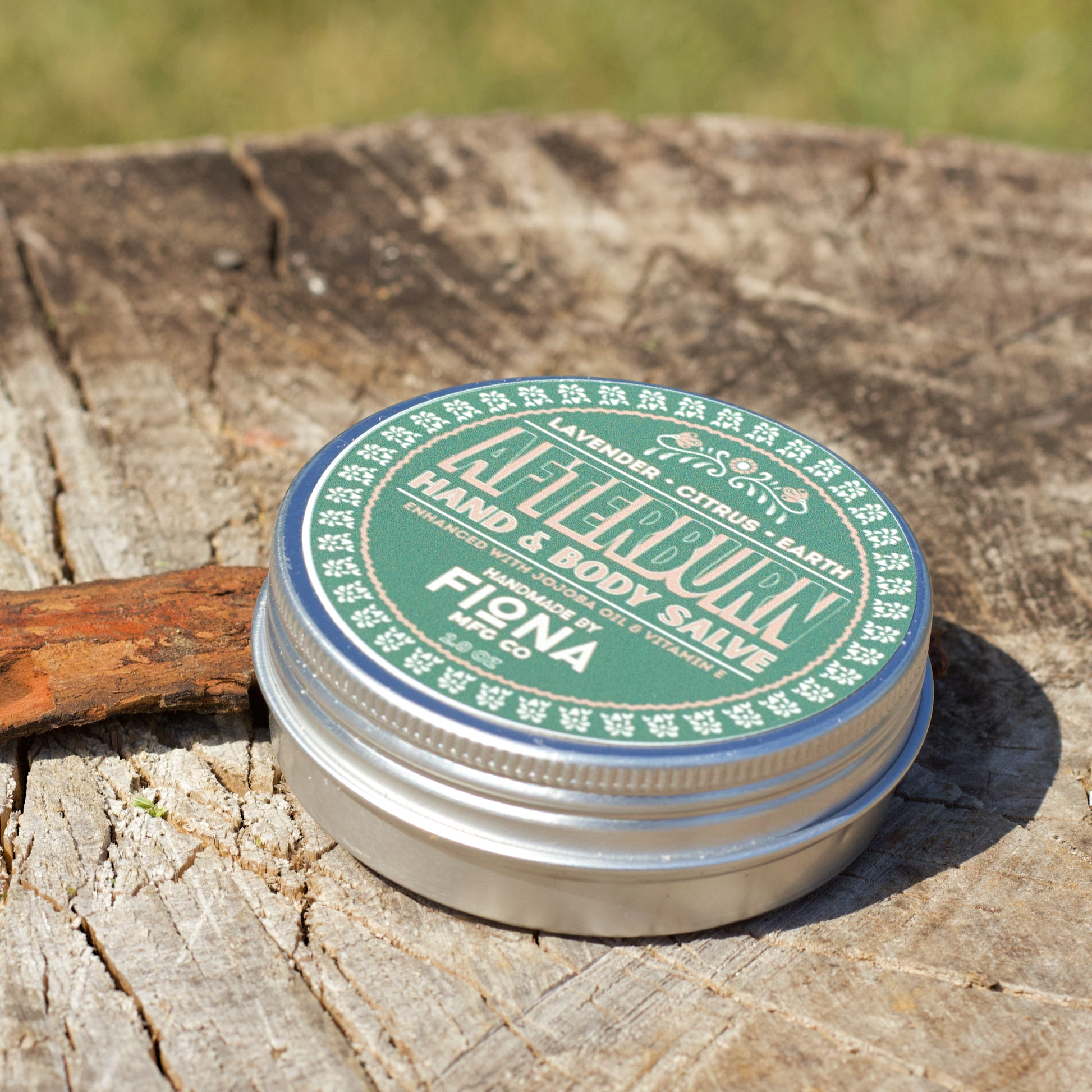 Container of Salve on a wooden surface with a blurred natural background