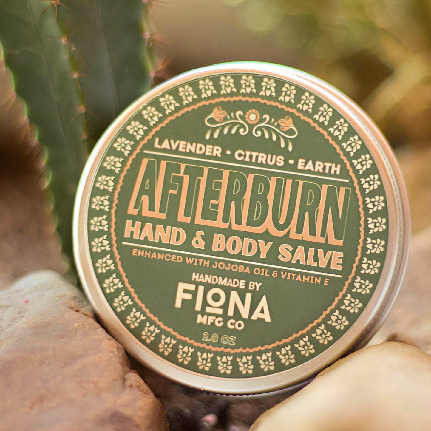 Afterburn hand & body salve tin on a natural background with plants