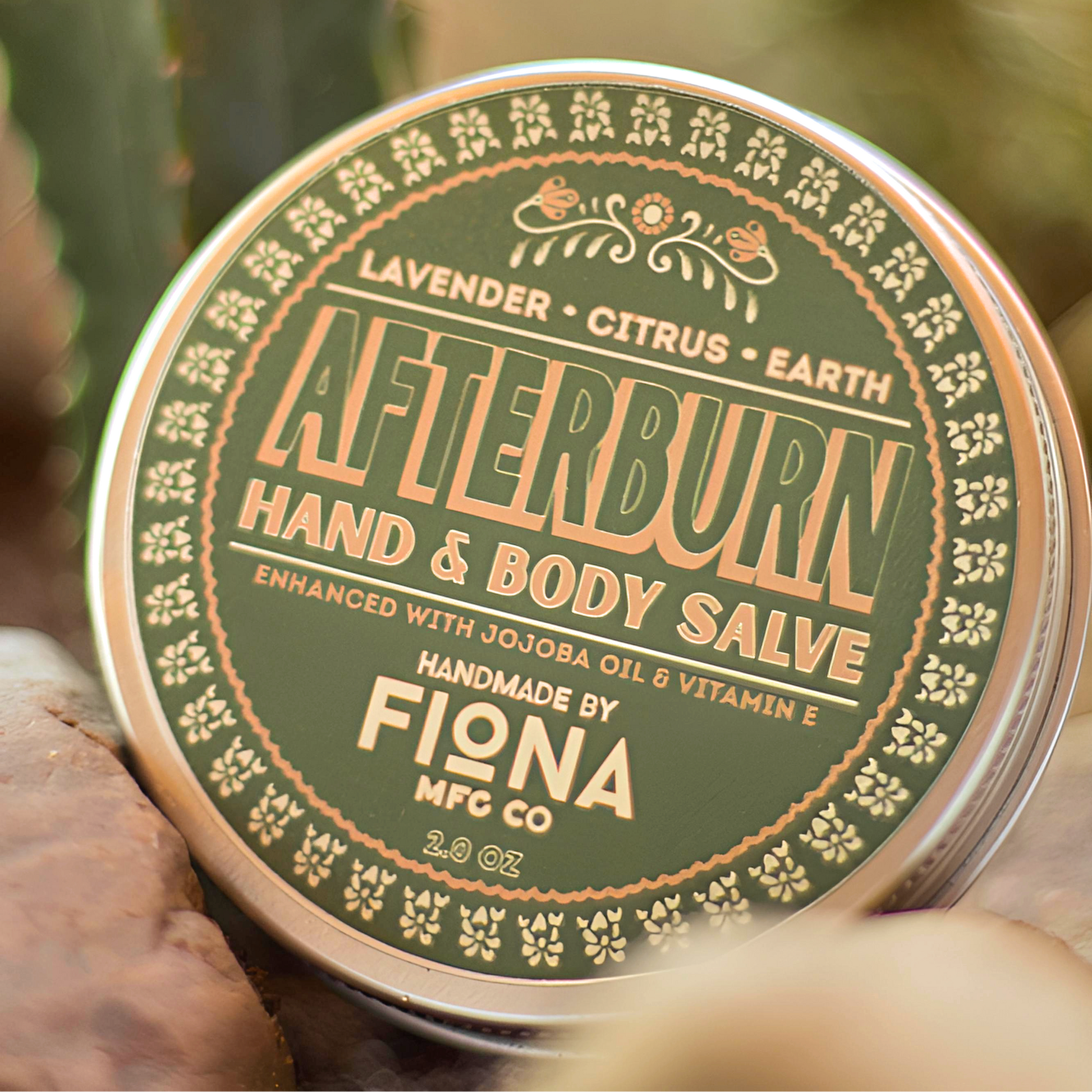 Afterburn hand and body salve tin with cactus in the background